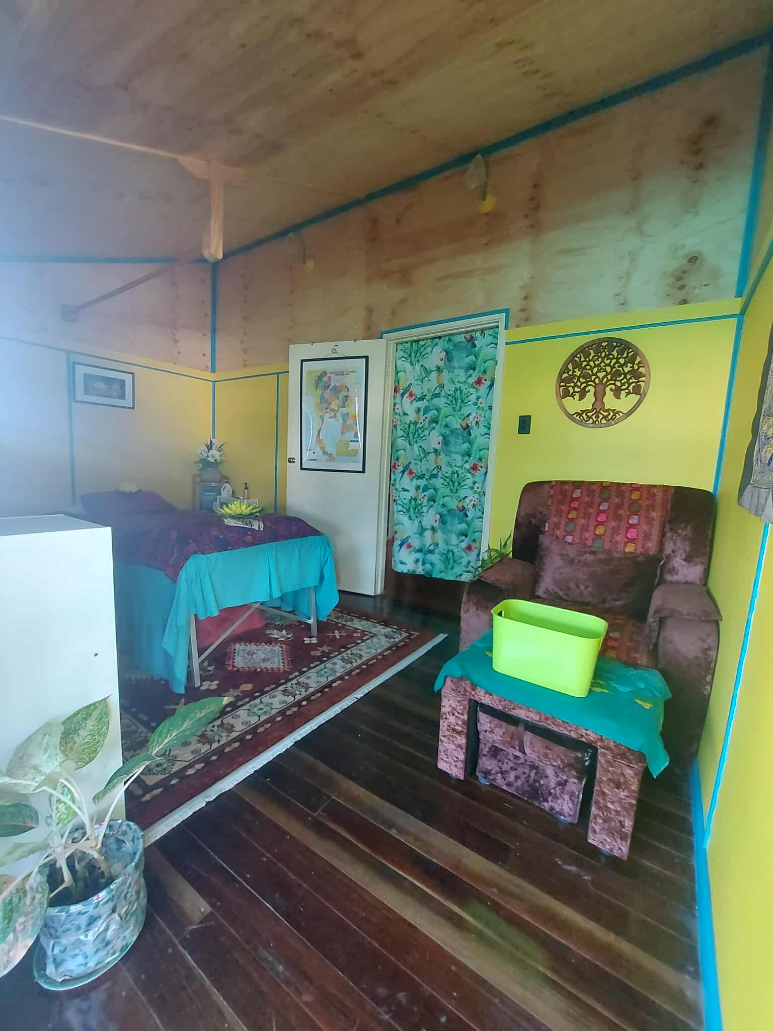 Waiting area with a recliner chair and a tree of life wall carving